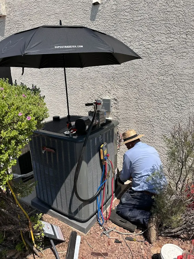 HVAC technician performing outdoor AC maintenance in Crete